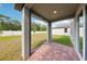 Covered patio with brick flooring offers outdoor living space at 4705 Jasmine Cir, Leesburg, FL 34748