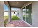 View of the covered patio with brick flooring, providing a cozy outdoor space at 4705 Jasmine Cir, Leesburg, FL 34748