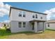 Rear exterior showing the covered patio area and upper level windows at 4705 Jasmine Cir, Leesburg, FL 34748