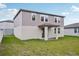 Back of house view featuring a green lawn and gray siding at 4721 Jasmine Cir, Leesburg, FL 34748