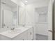 A bathroom featuring dual sinks and a view of the upstairs hallway at 4721 Jasmine Cir, Leesburg, FL 34748