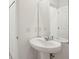 Bathroom featuring a sleek pedestal sink and a large mirror at 4721 Jasmine Cir, Leesburg, FL 34748