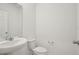 Bathroom featuring a sleek pedestal sink and a modern toilet at 4721 Jasmine Cir, Leesburg, FL 34748