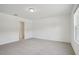 A bright bedroom with neutral carpet, white walls, and a large window at 4721 Jasmine Cir, Leesburg, FL 34748