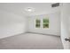 Bedroom with plush carpet and windows offering natural light at 4721 Jasmine Cir, Leesburg, FL 34748