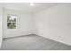 A well-lit bedroom featuring a window overlooking the outdoors at 4721 Jasmine Cir, Leesburg, FL 34748