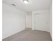 This carpeted bedroom offers neutral walls and a double door closet at 4721 Jasmine Cir, Leesburg, FL 34748