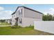 Two-story home with gray siding, white trim, well-maintained lawn, and a partially fenced yard at 4721 Jasmine Cir, Leesburg, FL 34748