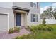 Charming front entrance with a blue front door, manicured landscaping, and a brick walkway at 4721 Jasmine Cir, Leesburg, FL 34748