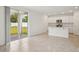 Living room that overlooks a modern kitchen, sliding glass doors, and tile flooring at 4721 Jasmine Cir, Leesburg, FL 34748