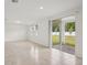 Open concept living room with tile flooring, recessed lighting, and sliding glass doors leading to the patio at 4721 Jasmine Cir, Leesburg, FL 34748