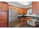 Kitchen with stainless steel appliances, granite countertops, and wooden cabinets at 4870 Conway Rd # 106, Orlando, FL 32812
