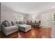Living room with hardwood floors, ample seating, and plenty of natural light at 4870 Conway Rd # 106, Orlando, FL 32812