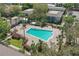 Aerial view of the community pool, surrounded by palm trees and lush landscaping at 4870 Conway Rd # 106, Orlando, FL 32812