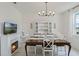 Formal dining area with a wooden table, seating for six, a fireplace and decorative china cabinet at 521 Sanctuary Blvd, Winter Haven, FL 33881