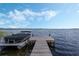 Scenic view of the dock and boat on the water, providing easy access to recreational activities at 521 Sanctuary Blvd, Winter Haven, FL 33881