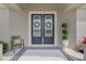 Charming double front door with glass detail, wreaths, and neutral tones for a welcoming entrance at 521 Sanctuary Blvd, Winter Haven, FL 33881
