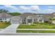 Charming single-story home featuring a two-car garage, well-maintained landscaping, and a welcoming front entrance at 521 Sanctuary Blvd, Winter Haven, FL 33881
