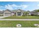 Charming single-story home showcasing well-manicured landscaping and a welcoming entrance, situated on a green lawn at 521 Sanctuary Blvd, Winter Haven, FL 33881