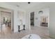 Bright hallway connecting the kitchen, living room, and dining area, offering an open and airy feel at 521 Sanctuary Blvd, Winter Haven, FL 33881