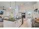 Open kitchen layout with a large island, modern appliances, and seamless flow to the living area at 521 Sanctuary Blvd, Winter Haven, FL 33881