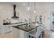 Bright kitchen boasting a large island with seating, stylish pendant lighting, and modern appliances at 521 Sanctuary Blvd, Winter Haven, FL 33881