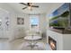 Cozy living room with a fireplace, white sofa, and a large window offering a picturesque outdoor view at 521 Sanctuary Blvd, Winter Haven, FL 33881