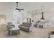 Open-concept living area with hardwood floors, modern furnishings, and a seamless flow into the kitchen at 521 Sanctuary Blvd, Winter Haven, FL 33881