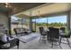 Screened-in patio with outdoor dining and lounge area, ceiling fan and view of backyard at 521 Sanctuary Blvd, Winter Haven, FL 33881