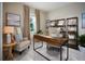 Home office features stylish desk, comfortable seating, and plenty of storage on the shelving unit at 523 Silver Palm Dr, Haines City, FL 33844