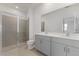 Modern bathroom with a double vanity, quartz countertops, a glass-enclosed shower, and updated fixtures at 527 Silver Palm Dr, Haines City, FL 33844
