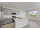 Bright kitchen with quartz countertops, stainless steel appliances, and an open layout leading to the dining area at 527 Silver Palm Dr, Haines City, FL 33844