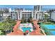 Aerial showcases condo community's pools, lush grounds, tennis courts, proximity to the beach and attractive landscaping at 5300 S Atlantic Ave # 2-505, New Smyrna Beach, FL 32169