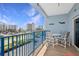 Balcony shows seating area, ocean views, and inviting outdoor living space overlooking city and tropical landscaping at 5300 S Atlantic Ave # 2-505, New Smyrna Beach, FL 32169