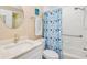 Charming bathroom featuring a vanity with marble countertop and shower with whale shower curtain at 5300 S Atlantic Ave # 2-505, New Smyrna Beach, FL 32169