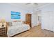 Bright bedroom featuring a daybed, wood floors, and serene ocean artwork at 5300 S Atlantic Ave # 2-505, New Smyrna Beach, FL 32169