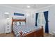 Bedroom featuring a full-sized bed, blue accent wall and natural light creating a relaxing space at 5300 S Atlantic Ave # 2-505, New Smyrna Beach, FL 32169