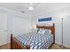 Cozy bedroom featuring a comfortable bed, ceiling fan, and ample closet space at 5300 S Atlantic Ave # 2-505, New Smyrna Beach, FL 32169