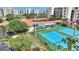 This shows the outdoor pool and tennis and shuffleboard courts with condos in the background at 5300 S Atlantic Ave # 2-505, New Smyrna Beach, FL 32169