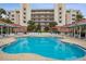 Gorgeous community pool area, with spacious sundeck surrounded by beautiful palms, providing a resort-style oasis at 5300 S Atlantic Ave # 2-505, New Smyrna Beach, FL 32169