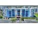 Beautiful condo building with many balconies, parking, and lush landscaping at 5300 S Atlantic Ave # 2-505, New Smyrna Beach, FL 32169