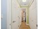 Hallway view leading to a charming bathroom with white doors and light green walls at 5300 S Atlantic Ave # 2-505, New Smyrna Beach, FL 32169