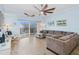 Inviting living room featuring a large sofa, comfy rocking chair and balcony access at 5300 S Atlantic Ave # 2-505, New Smyrna Beach, FL 32169