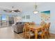 Open concept living and dining area with beautiful artwork and lots of natural light at 5300 S Atlantic Ave # 2-505, New Smyrna Beach, FL 32169