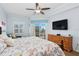 Main bedroom featuring balcony access, neutral walls, and ceiling fan that makes this room a true retreat at 5300 S Atlantic Ave # 2-505, New Smyrna Beach, FL 32169