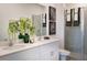 Bright bathroom with a double vanity, quartz countertop, and a glass-enclosed shower at 531 Silver Palm Dr, Haines City, FL 33844