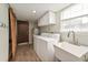 Laundry room featuring a modern washer and dryer, plus wood look tile at 5330 Keswick Ct, Orlando, FL 32812