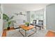 Cozy living room featuring hardwood floors, neutral walls, and large windows for natural light at 5330 Keswick Ct, Orlando, FL 32812