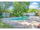 Backyard pool with stone tile and a small waterfall at 5330 Keswick Ct, Orlando, FL 32812