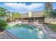 Backyard pool with brick tile steps and a screened in patio at 5330 Keswick Ct, Orlando, FL 32812